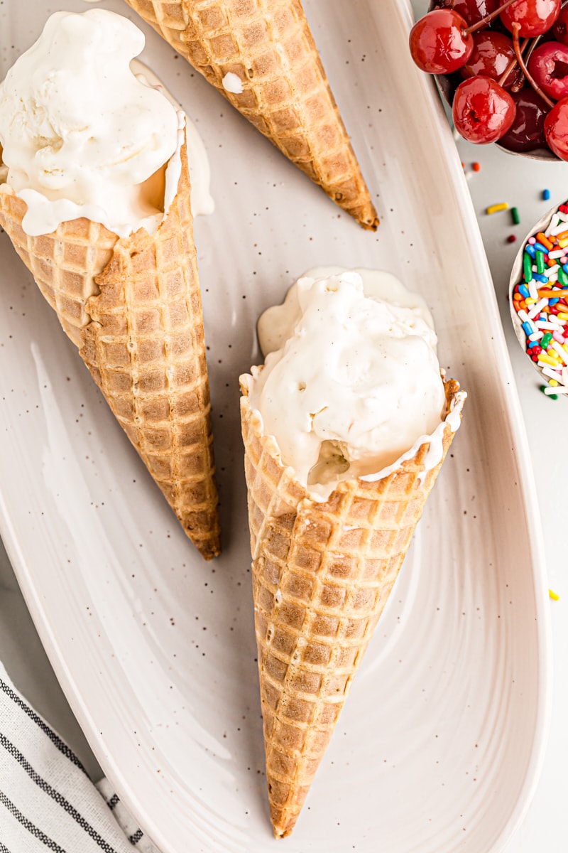 3 waffle cones of vanilla ice cream on serving platter