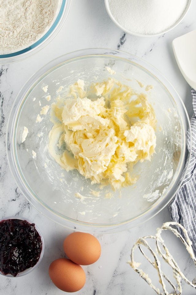 overhead view of creamed butter in a glass mixing bowl