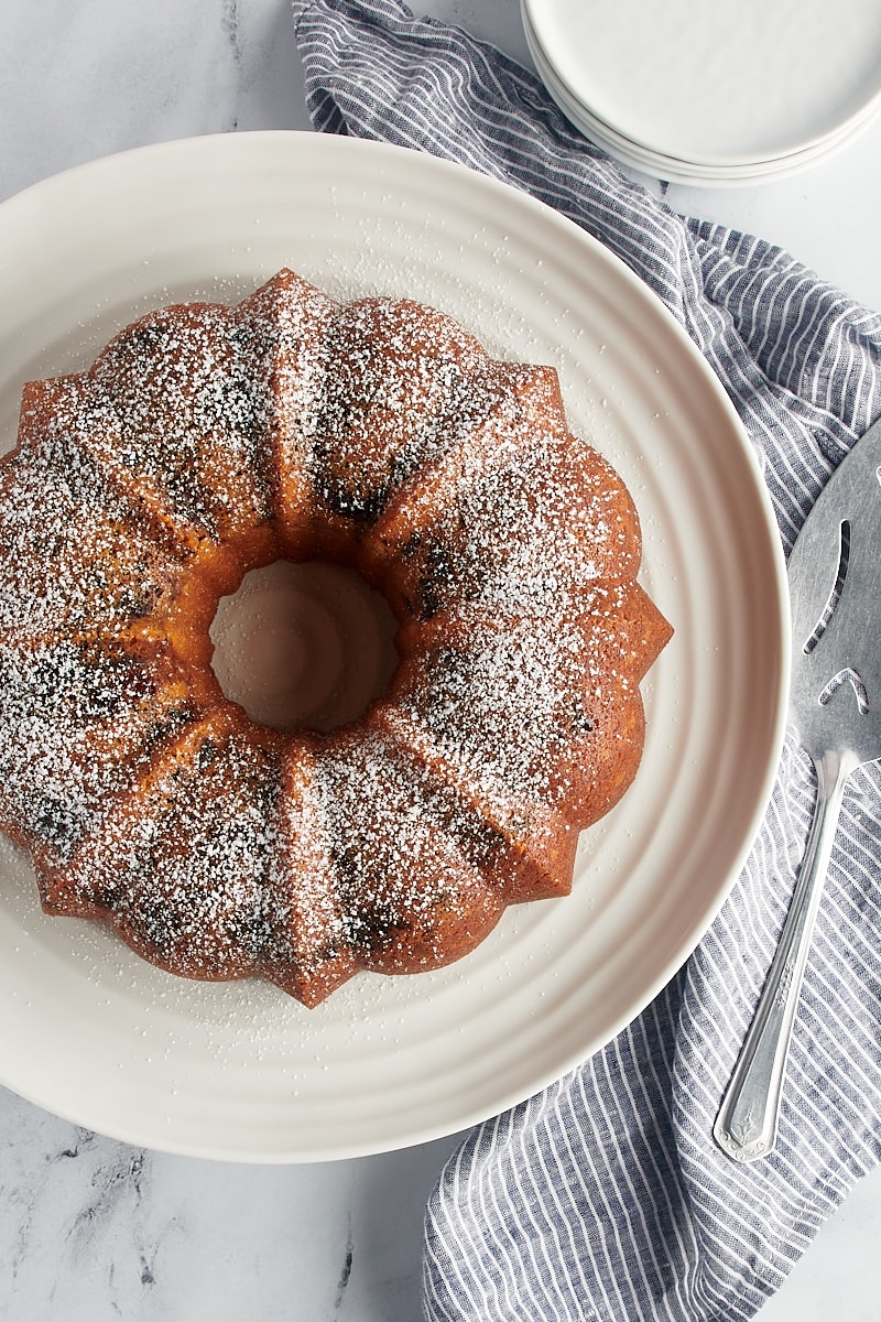 overhead view of black cherry sour cream coffee cake dusted with powdered sugar