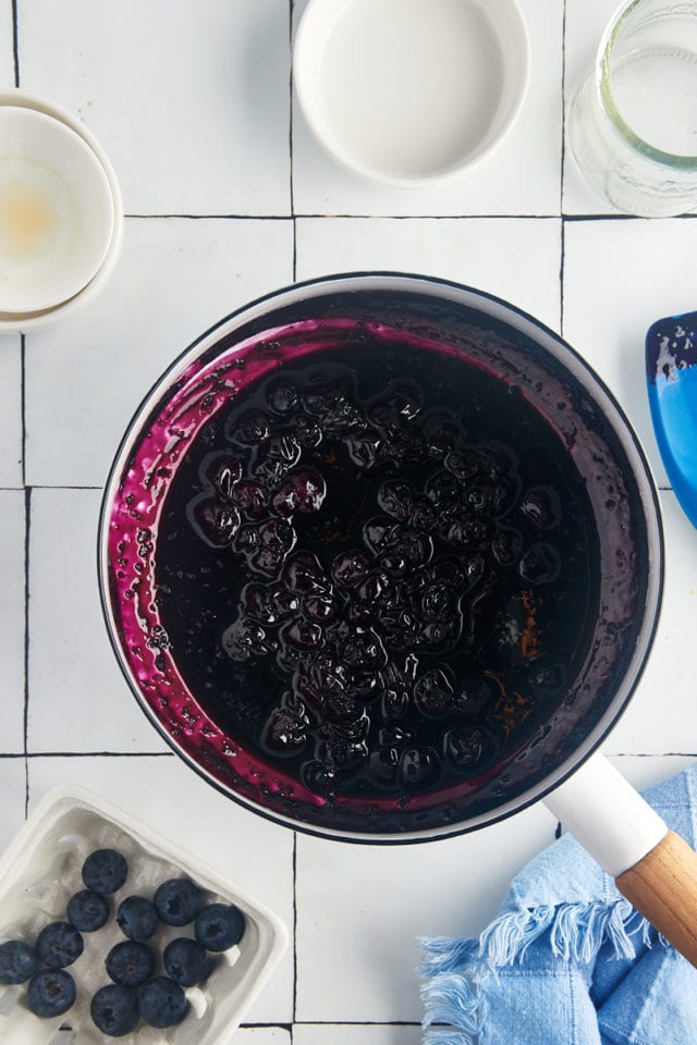 overhead view of blueberry compote in a white saucepan