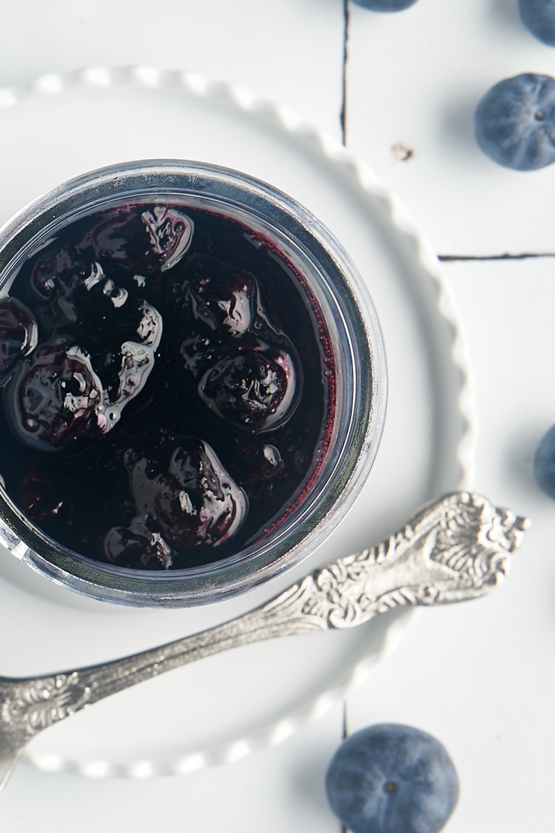overhead view of blueberry compote in a glass jar
