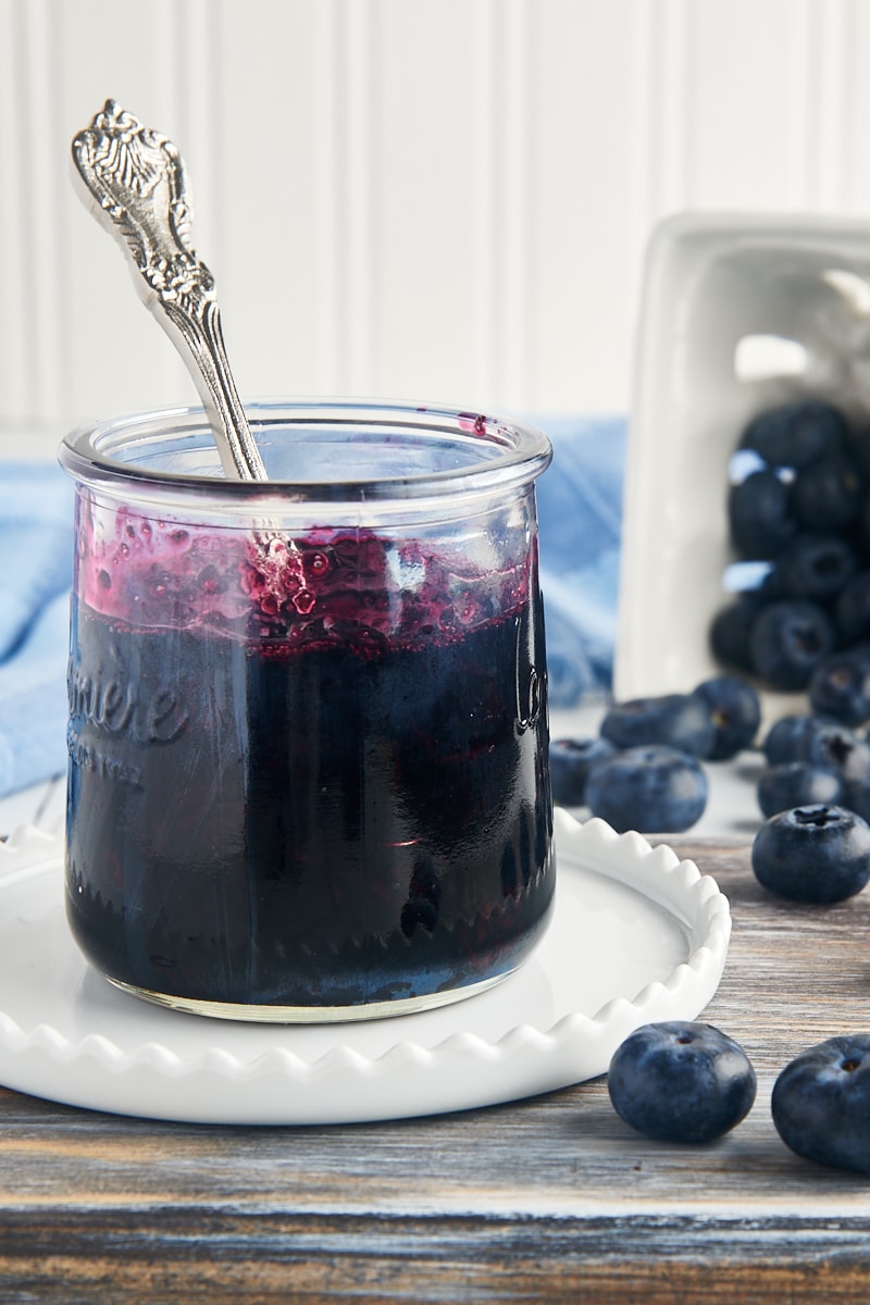 a glass jar filled with blueberry compote