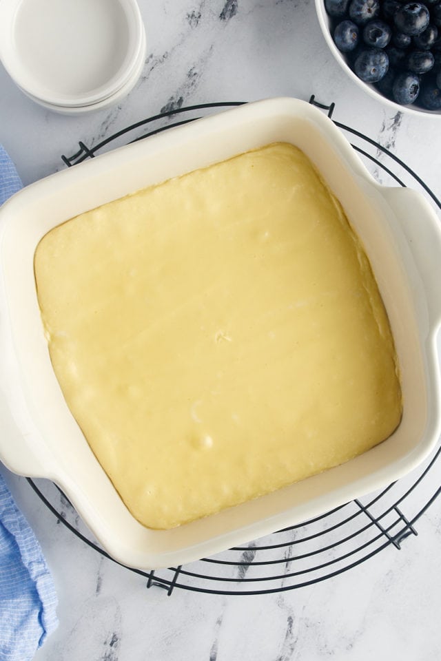 Overhead view of cream cheese layer in baking dish