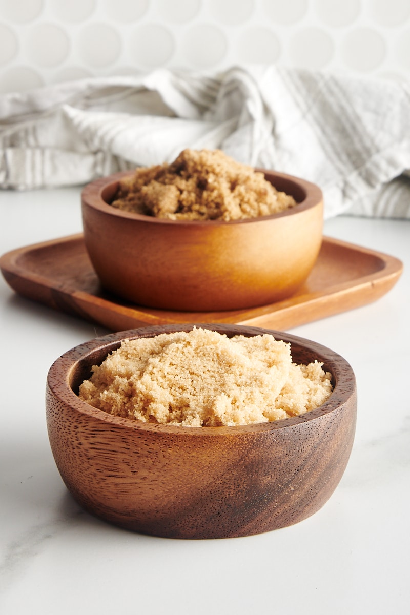 light and dark brown sugar in wooden bowls