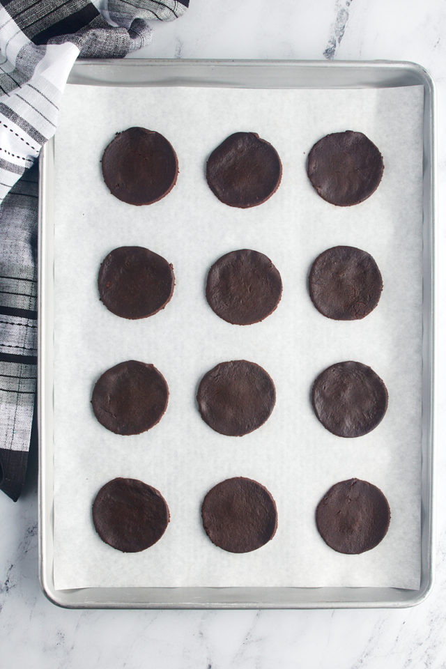 overhead view of chocolate wafer cookies on a parchment-lined baking sheet ready to go into the oven