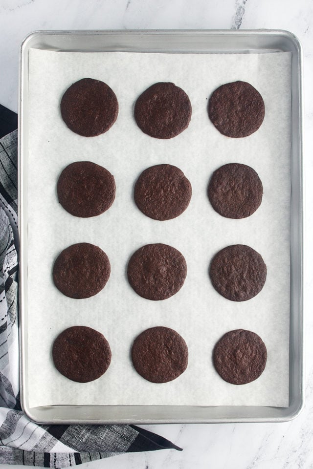 overhead view of freshly baked chocolate wafer cookies on a baking sheet