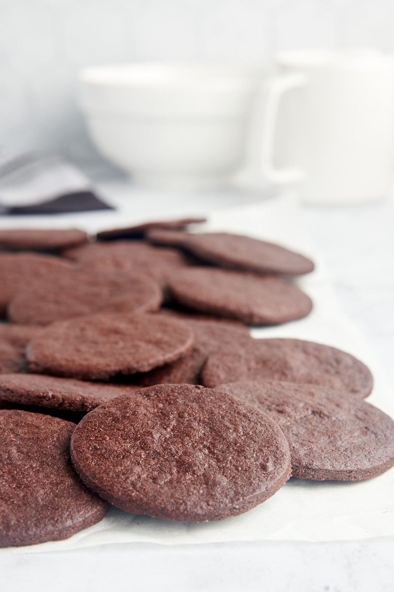 chocolate wafer cookies scattered on white parchment paper