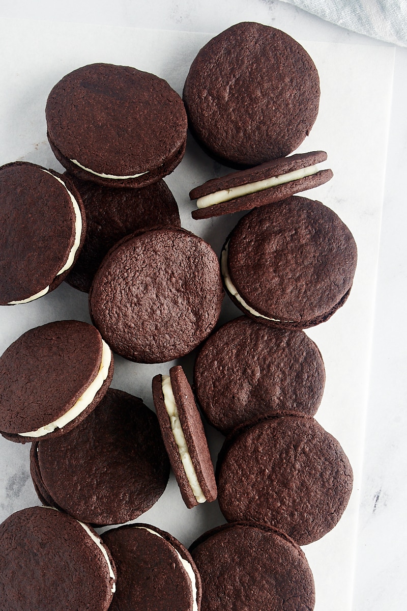 overhead view of homemade Oreos scattered on a marble surface