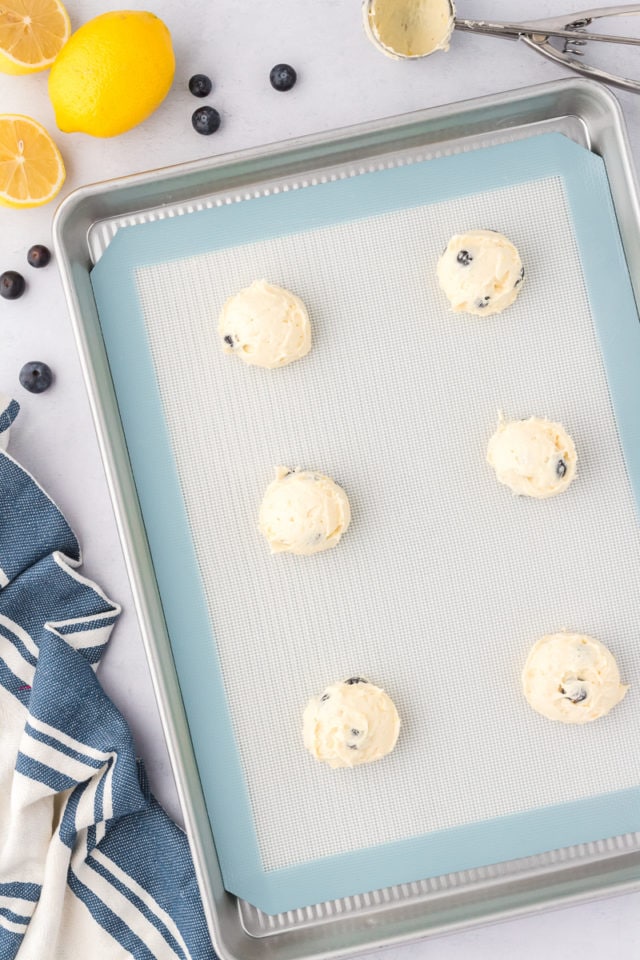 overhead view of lemon blueberry cookies on a baking sheet ready to go into the oven