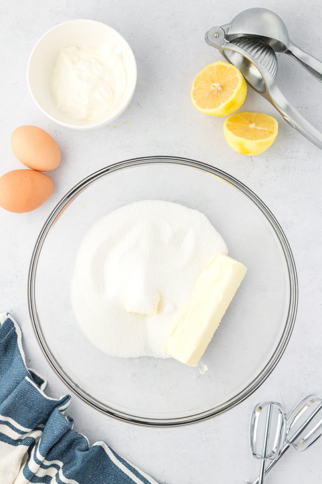 overhead view of sugar and butter in a glass mixing bowl