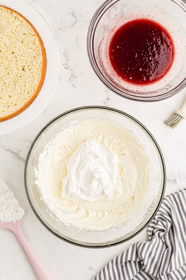 Overhead view of small amount of whipped cream added to mascarpone and cream cheese