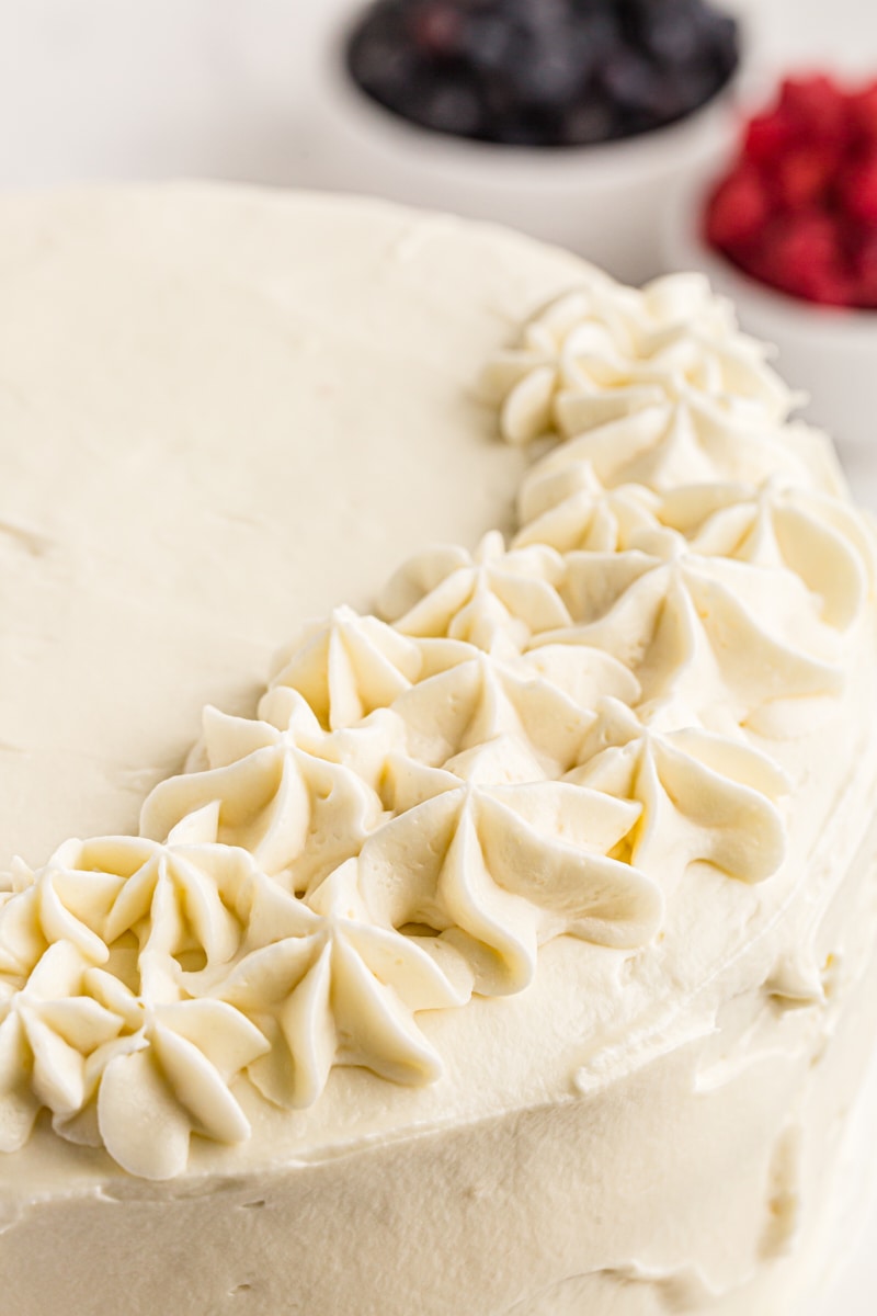 Closeup of chantillly cake with piped stars on side