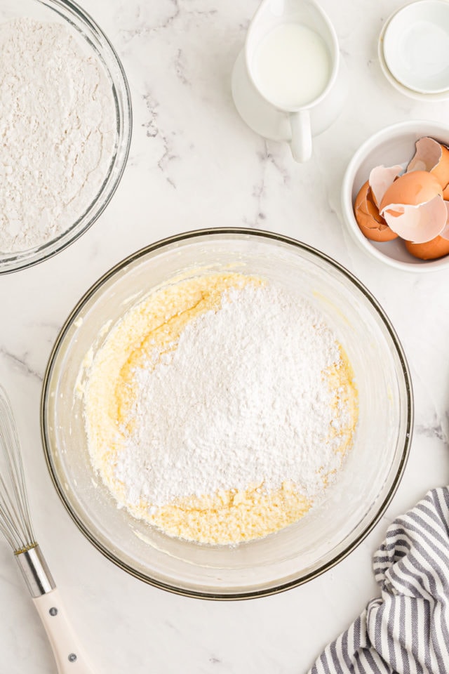 Overhead view of dry ingredients added to wet ingredients for cake