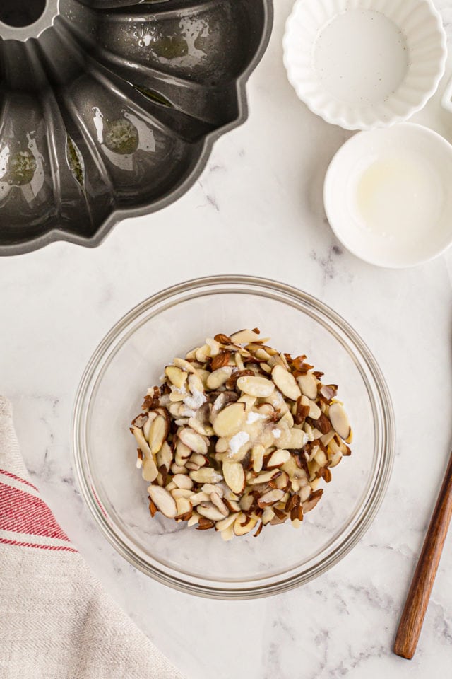 Overhead view of ingredients for almond topping in glass bowl