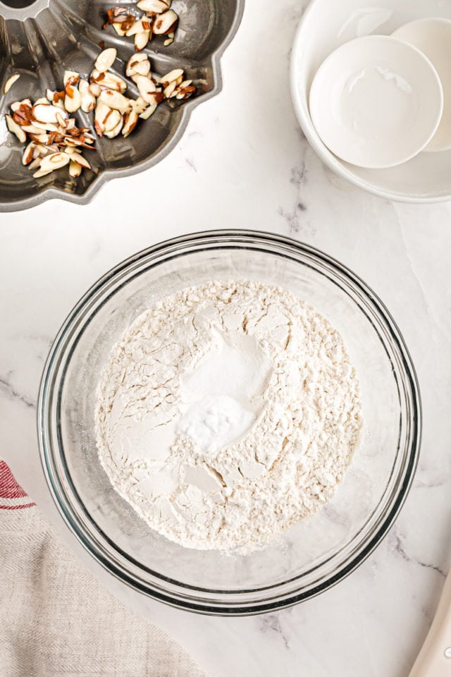 Overhead view of dry ingredients for cake in glass mixing bowl