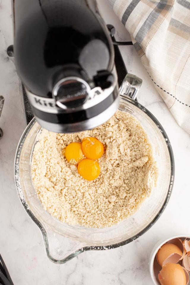 overhead view of egg yolks added to tart dough