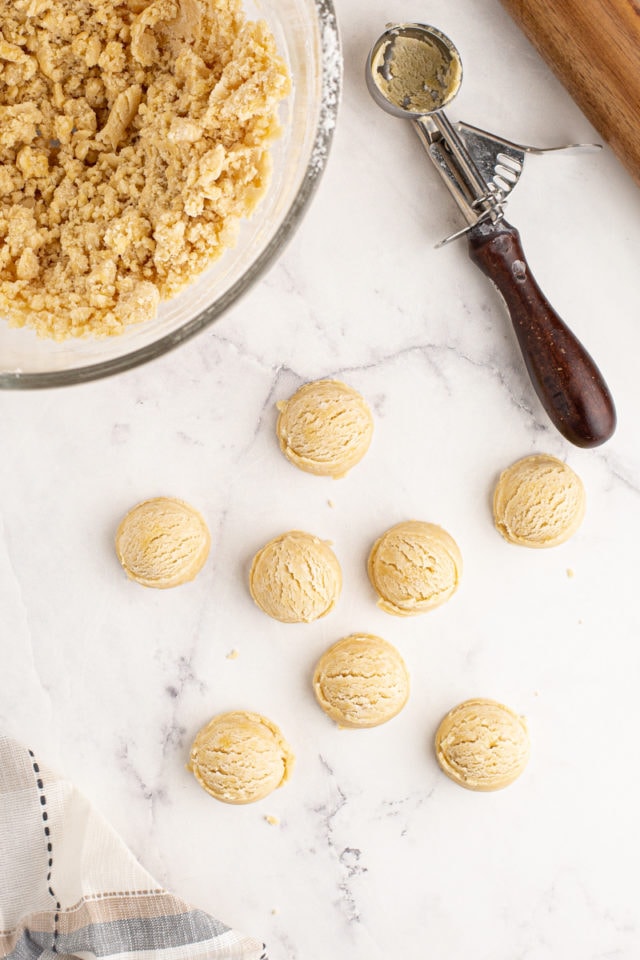 overhead view of portioned tart dough on a marble surface