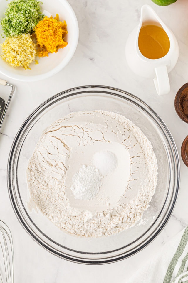 overhead view of flour, baking powder, and salt in a glass mixing bowl