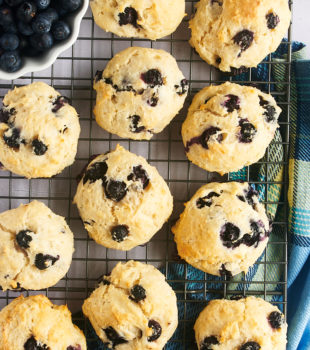 Overhead view of blueberry biscuits on wire cooling rack