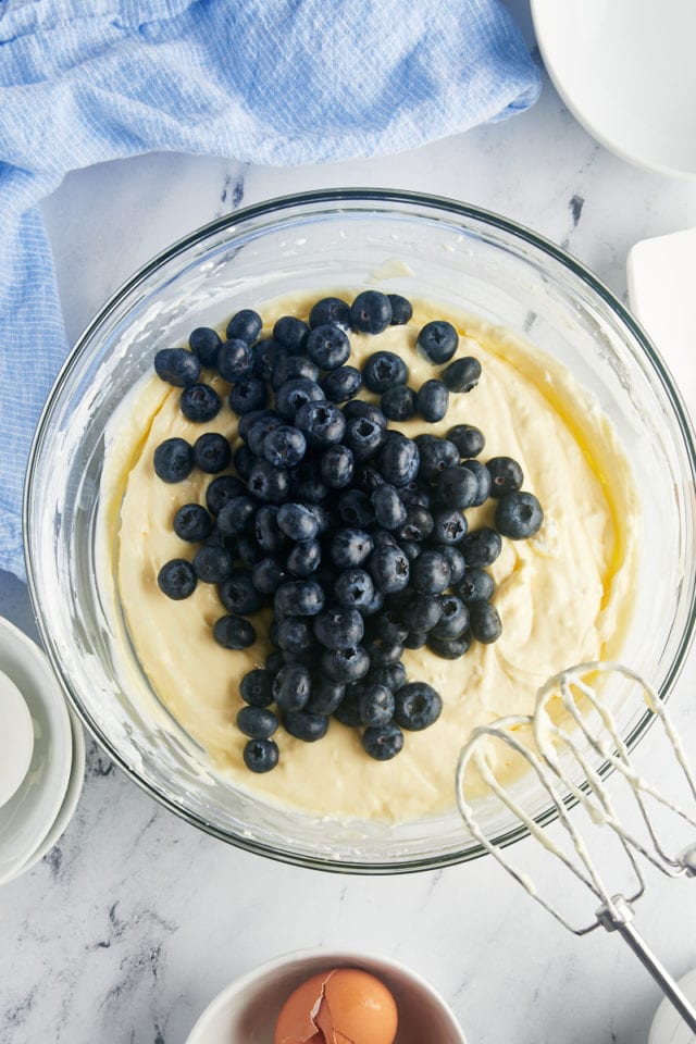 overhead view of blueberries added to cheesecake batter