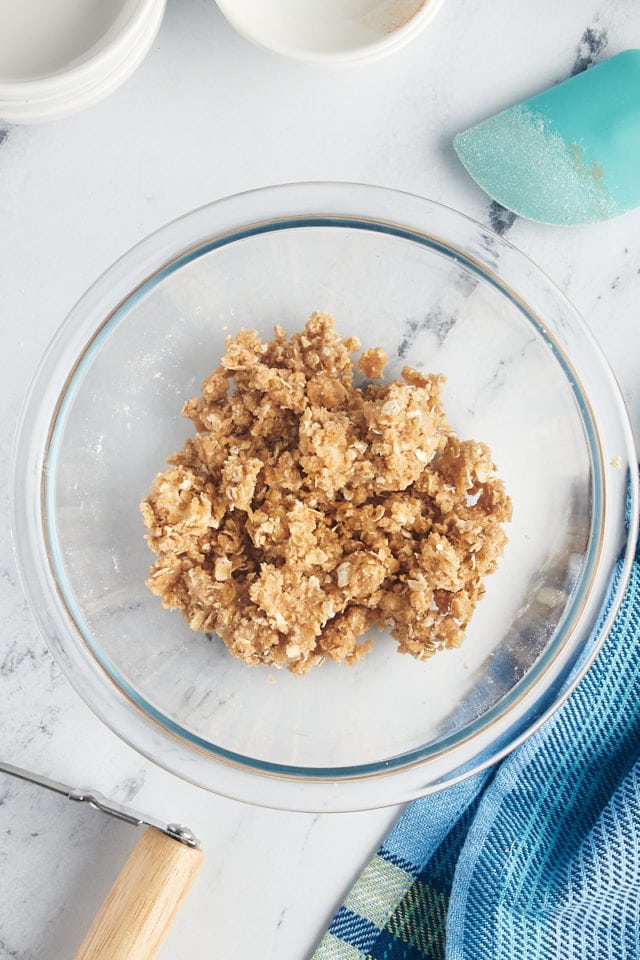Overhead view of crumble topping in glass bowl
