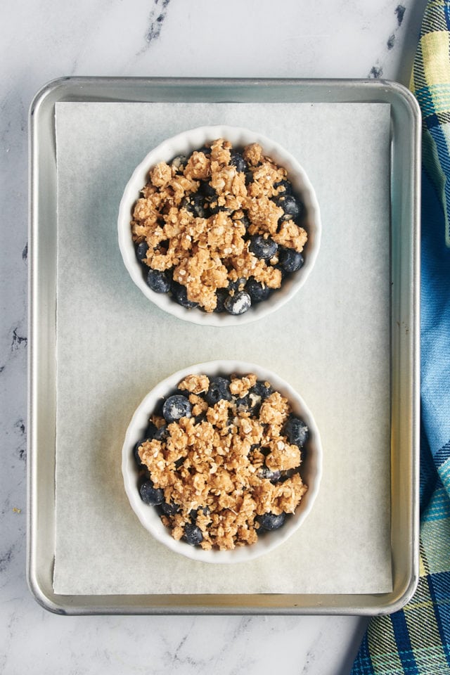 Overhead view of blueberry crumbles for two before baking