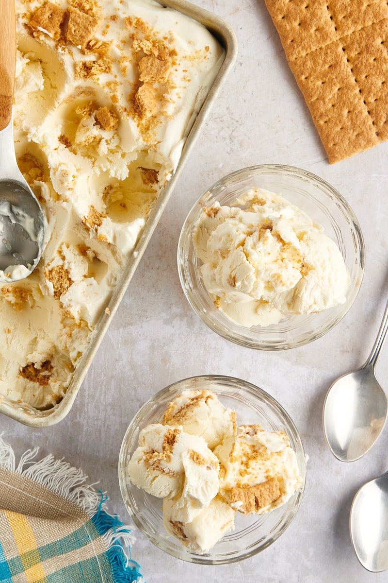 Overhead view of cheesecake ice cream in loaf pan and two glass bowls