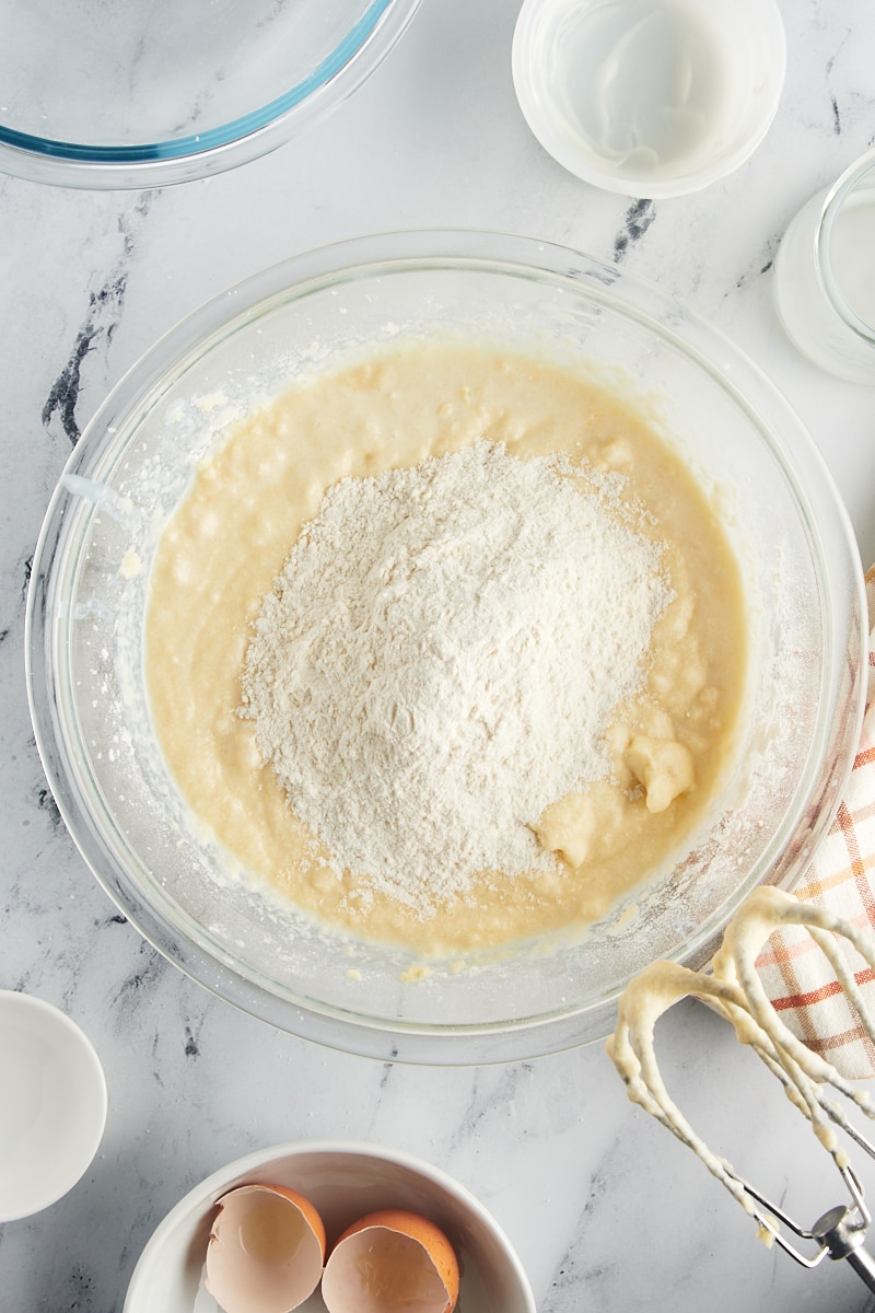 The final portion of dry ingredients being added to the raspberry coffee cake batter, ready for minimal mixing.