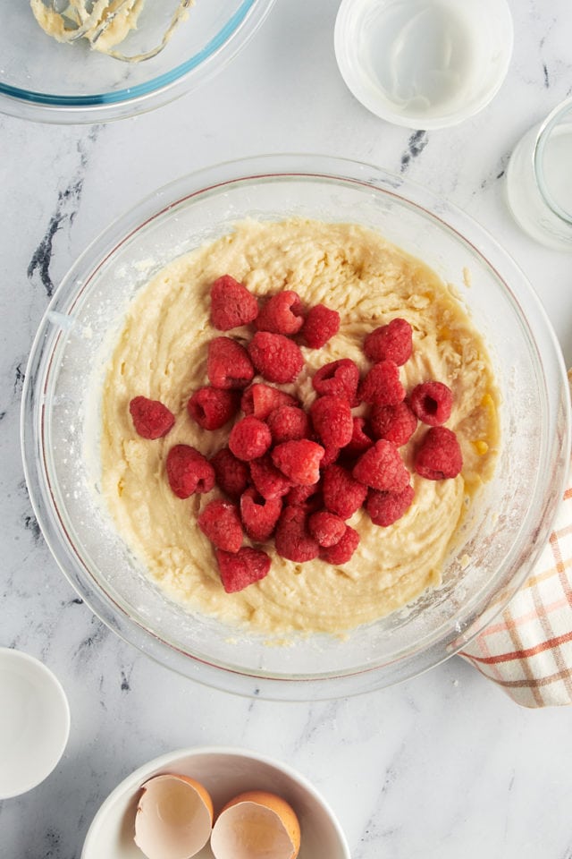 overhead view of raspberries added to cake batter