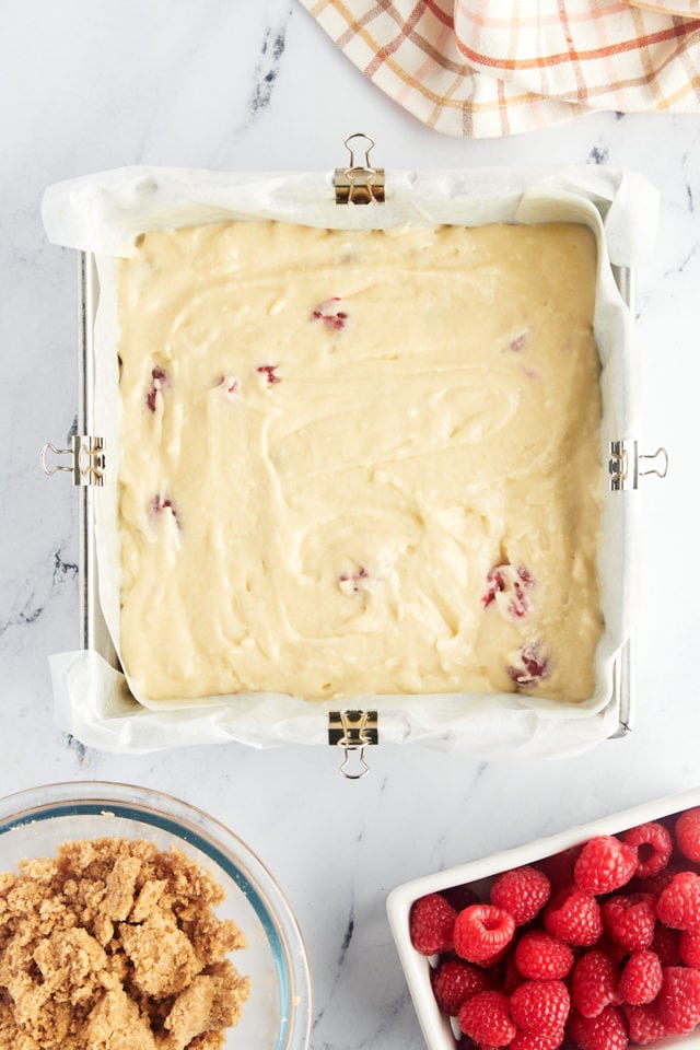 overhead view of raspberry coffee cake batter in a square baking pan