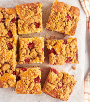 overhead view of slices of raspberry coffee cake on parchment paper