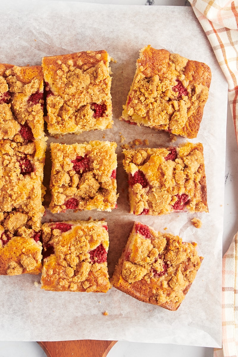 overhead view of slices of raspberry coffee cake on parchment paper