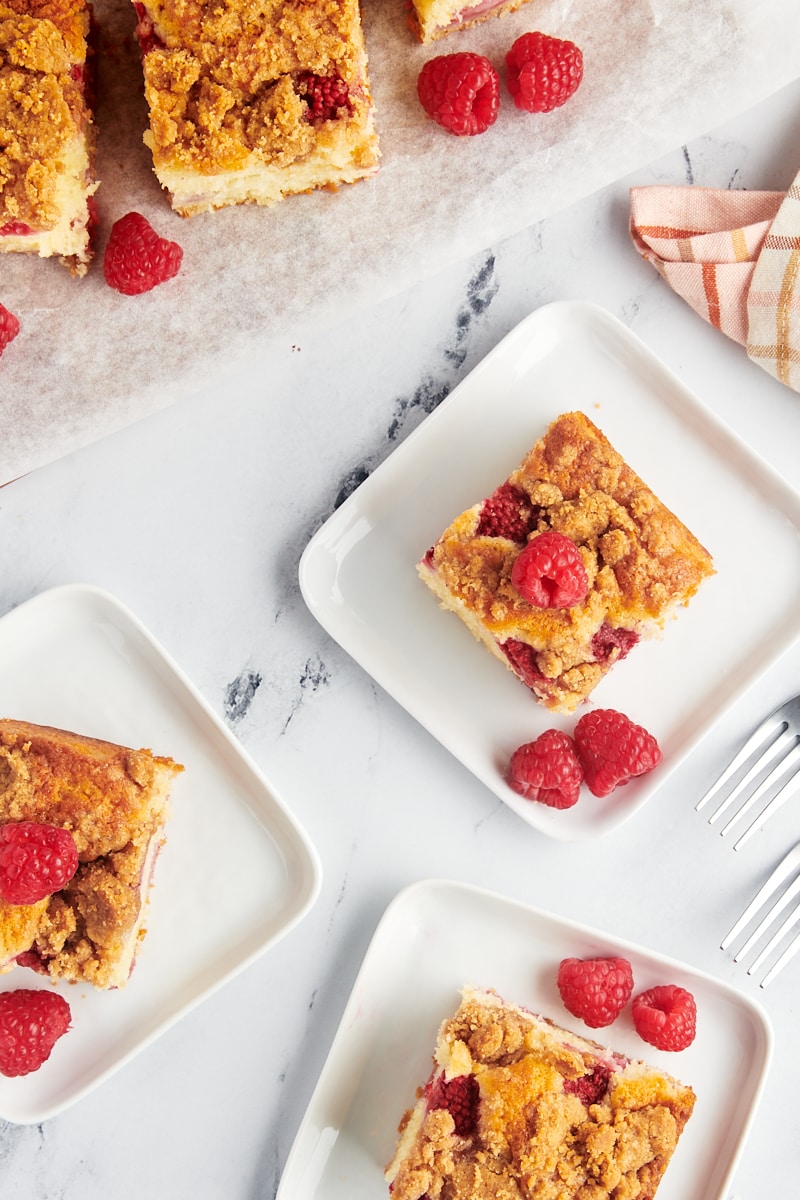 slices of raspberry coffee cake on square white plates