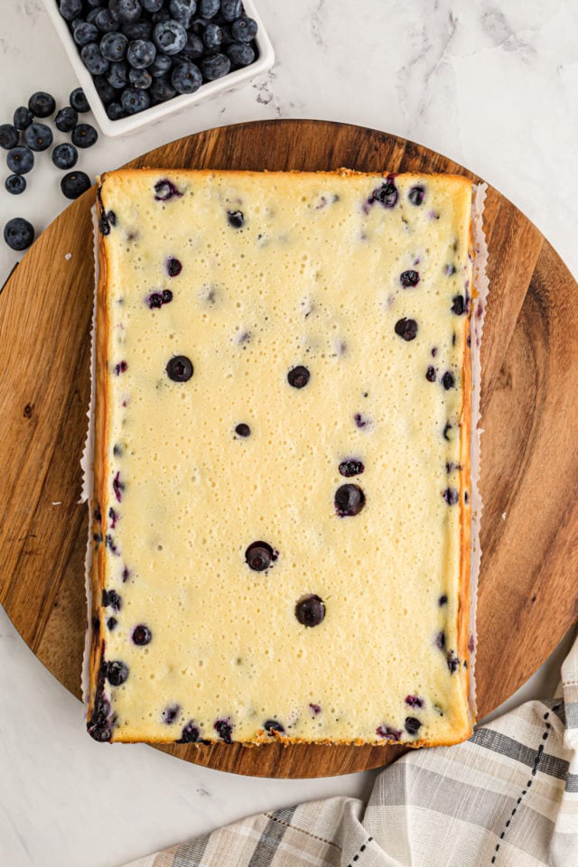 Uncut blueberry oat cheesecake bars on board