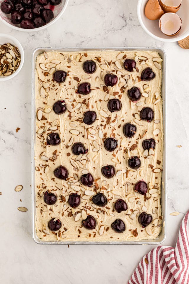 Overhead view of cherry almond sheet cake before baking