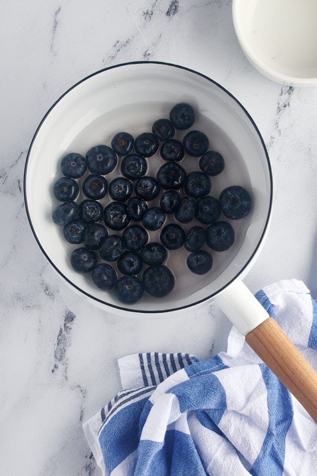 Overhead view of ingredients for blueberry topping in saucepan