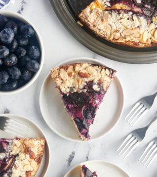 Overhead view of blueberry cream cheese coffee cake on plates and pan