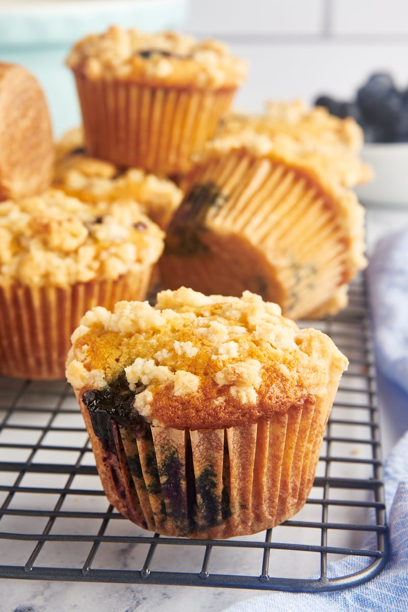 Side view of blueberry crumb muffins on wire rack