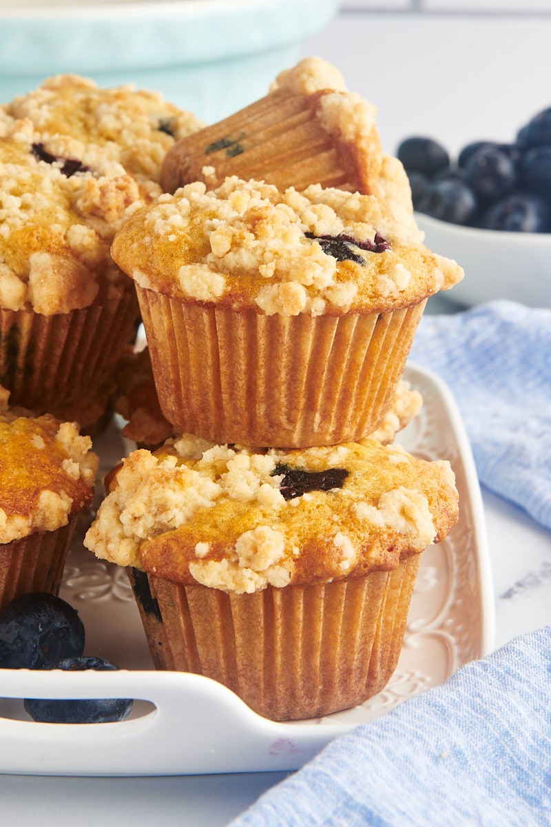 Stack of blueberry crumb muffins on platter