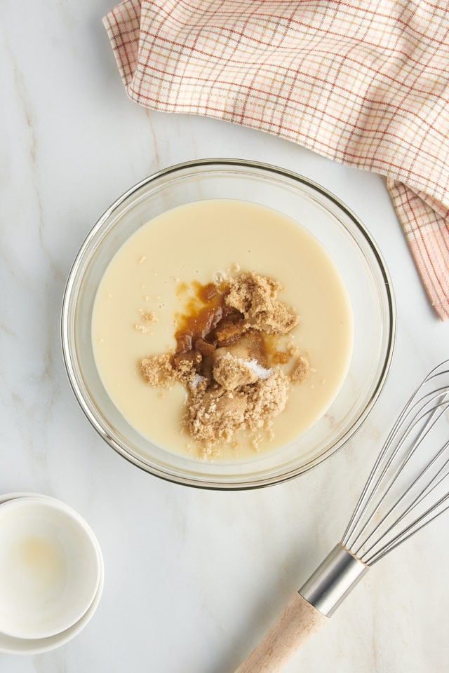 overhead view of sweetened condensed milk, brown sugar, vanilla extract, and salt in a glass mixing bowl