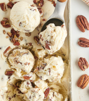 overhead view of scoops of butter pecan ice cream in a metal pan