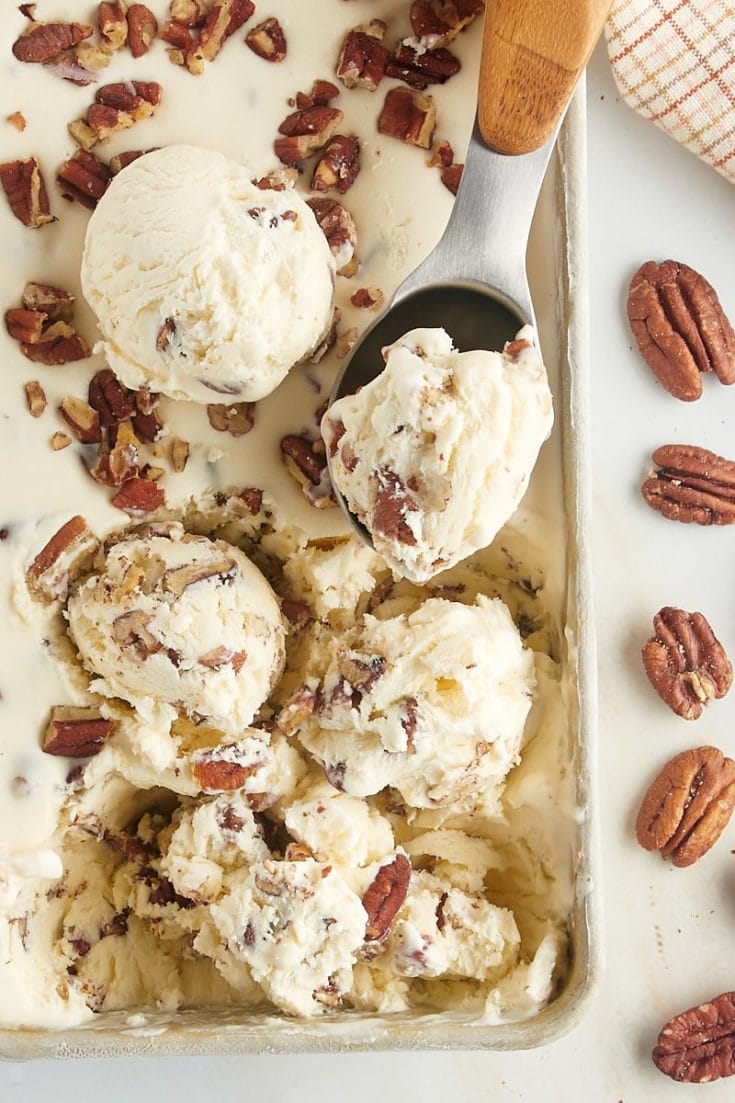 overhead view of scoops of butter pecan ice cream in a metal pan