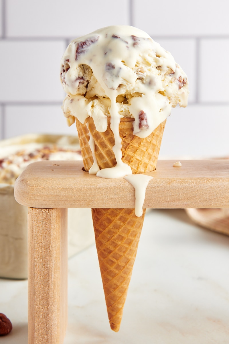 butter pecan ice cream in a waffle cone in a wooden stand