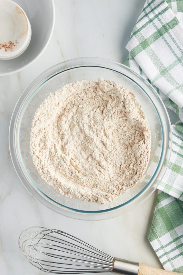 Overhead view of dry ingredients in glass mixing bowl