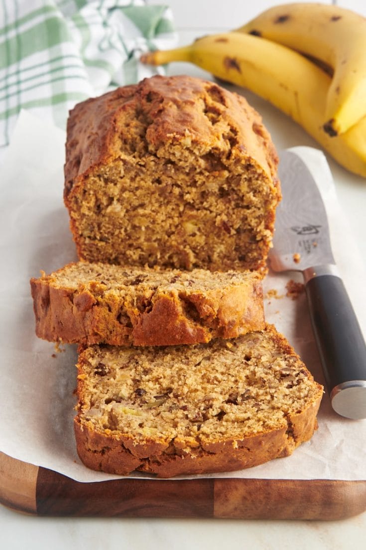 Sliced peanut butter banana bread on cutting board with knife