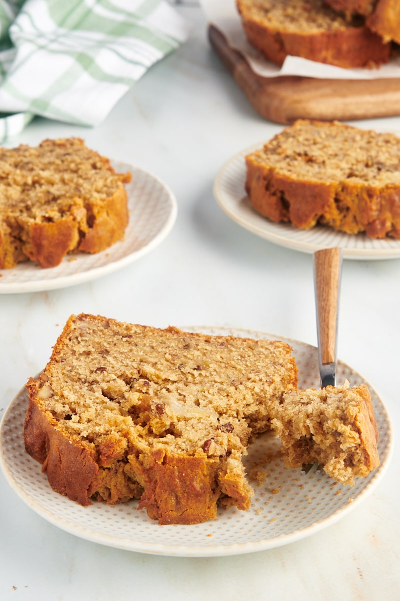 Slices of peanut butter banana bread on white plates