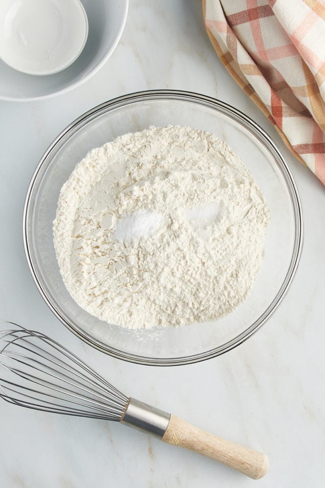 Overhead view of dry ingredients in a mixing bowl before whisking.