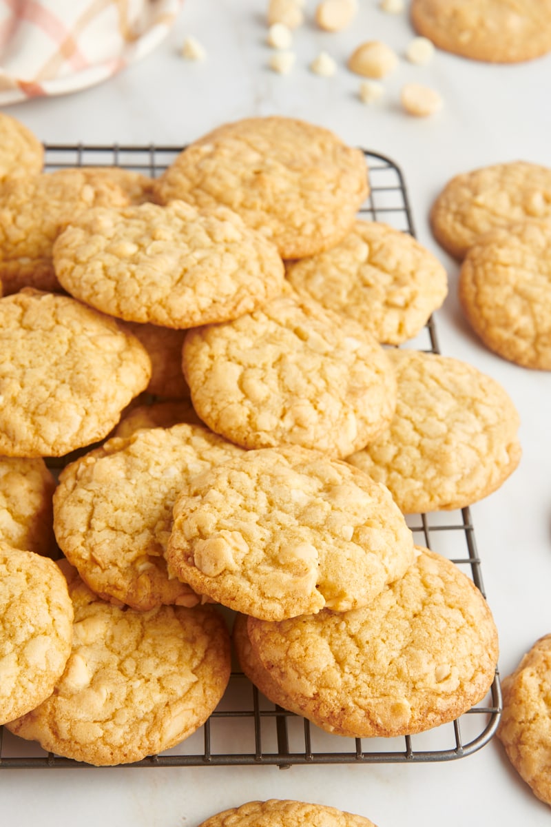 Stack of white chocolate macadamia nut cookies on a wire rack.