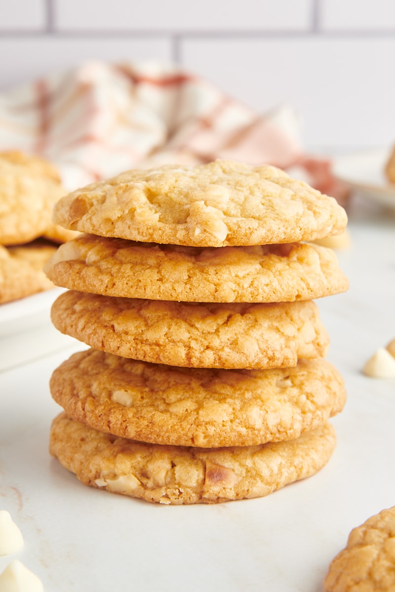 Stack of 5 white chocolate macadamia nut cookies.