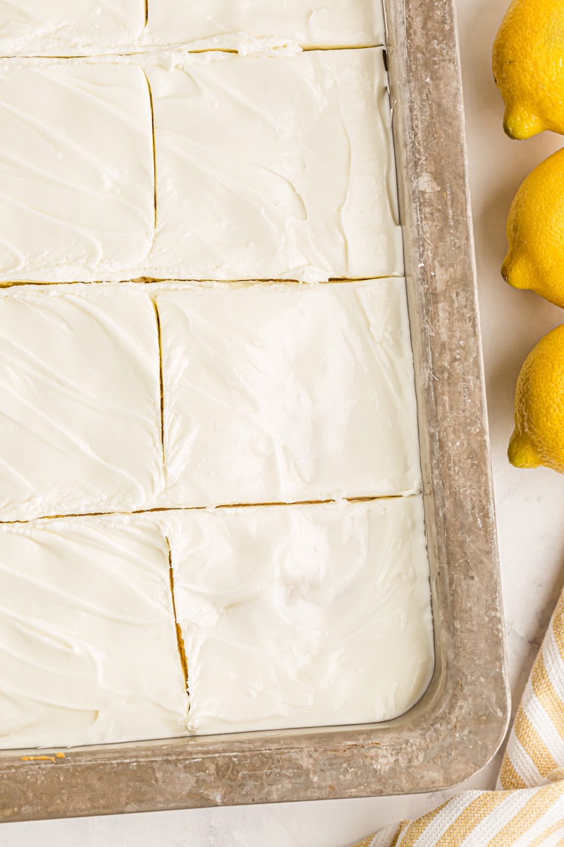 Overhead view of lemon poke cake cut in pan